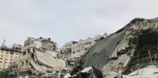 a large pile of rubble next to a dirt road