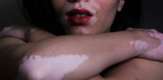 a close up of a woman with her arms crossed