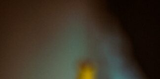 a close up of a yellow tape with a blurry background
