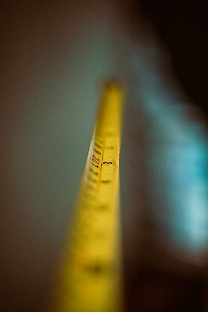 a close up of a yellow tape with a blurry background