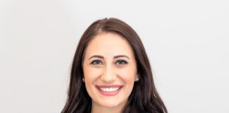woman in red cardigan smiling