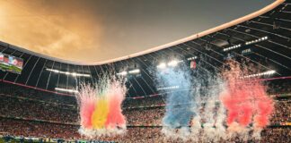 A stadium filled with lots of people watching a soccer game