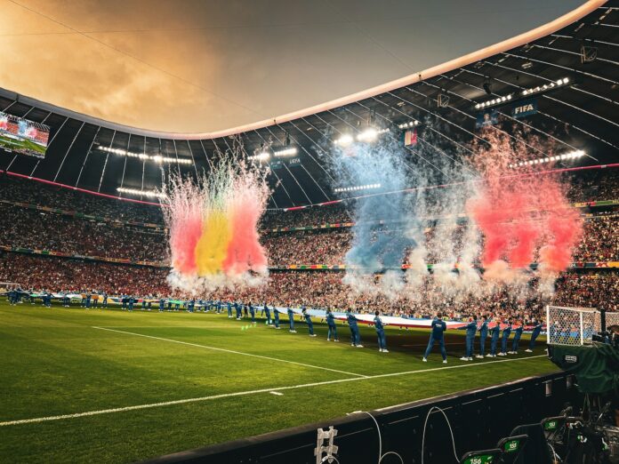 A stadium filled with lots of people watching a soccer game