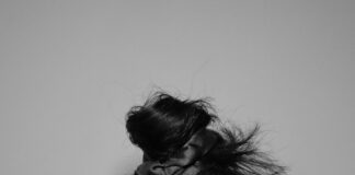a woman covering her face with her hands