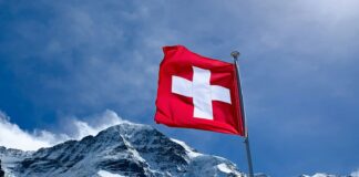 red flag on top of snow covered mountain