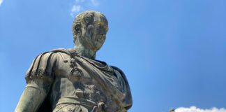 a statue of a person holding a gun