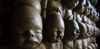 a bunch of little statues that are on a wall