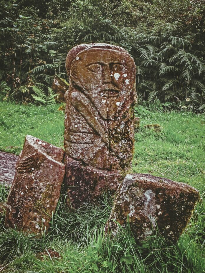 brown historic statue on green field