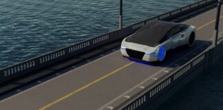 A futuristic car driving on a bridge over a body of water