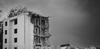 a black and white photo of a demolished building