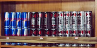 a shelf with many cans of beer on it