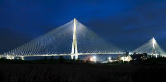 Cable-stayed bridge brightly lit at night.