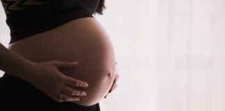 pregnant woman cradling her belly